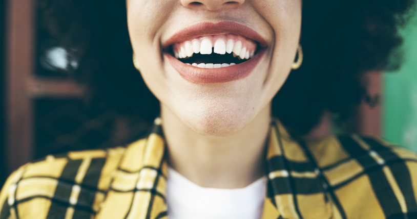 Cropped shot of an attractive young woman laughing in an urban setting Dentist in Strongsville Ohio